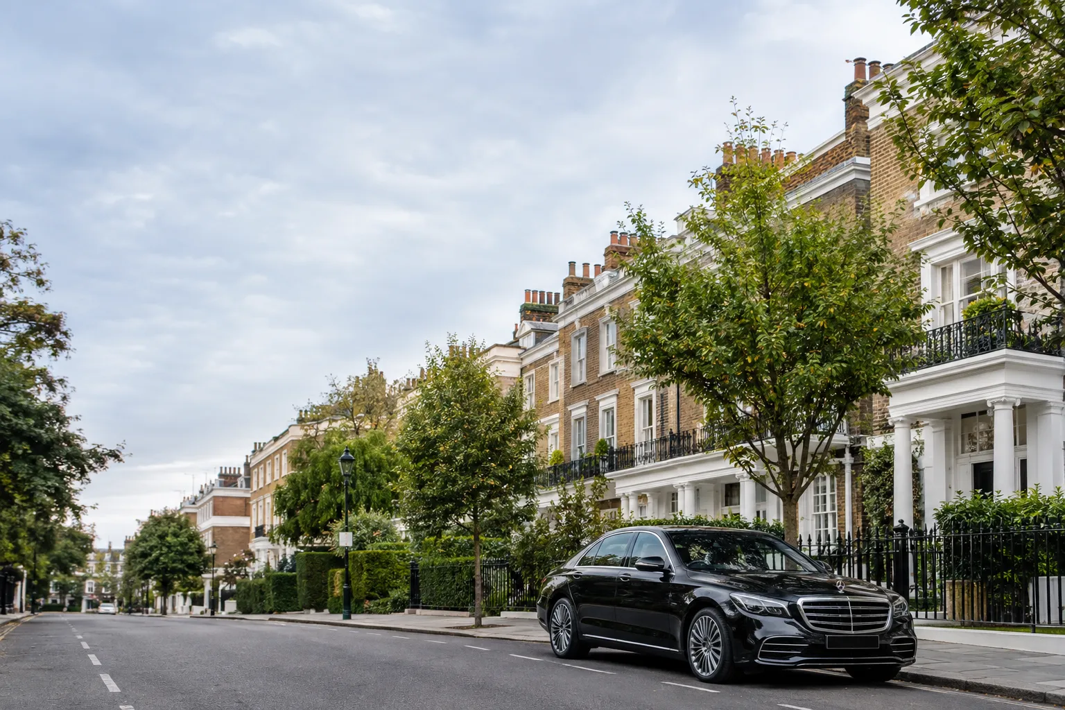 Leafy residential street with traditional townhouses in Chelsea, London.